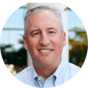 A man smiling while looking at the camera