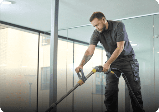 a young man cleaning the railing inside an office