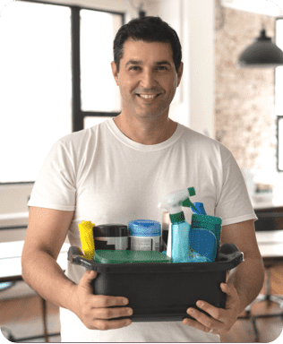 a cheerful man holding a basket of cleaning essentials