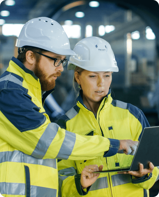 two contractors discussing with laptop