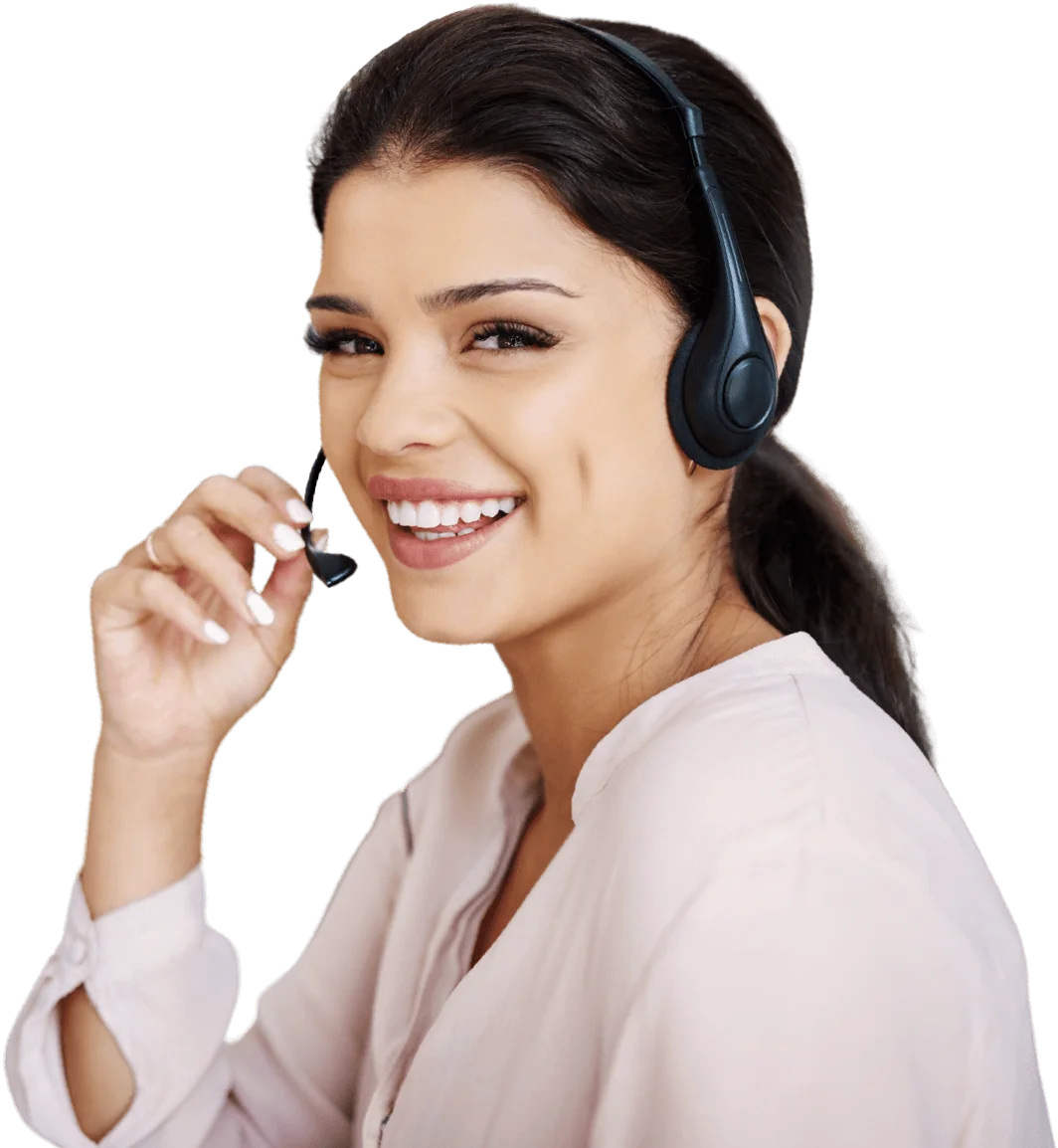 A smiling young woman in peach outfit wearing headphones and holding microphone.