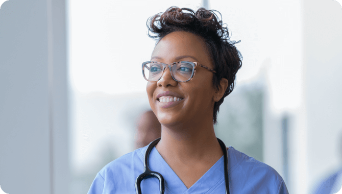 A smiling man on a phone call in a cafeteria