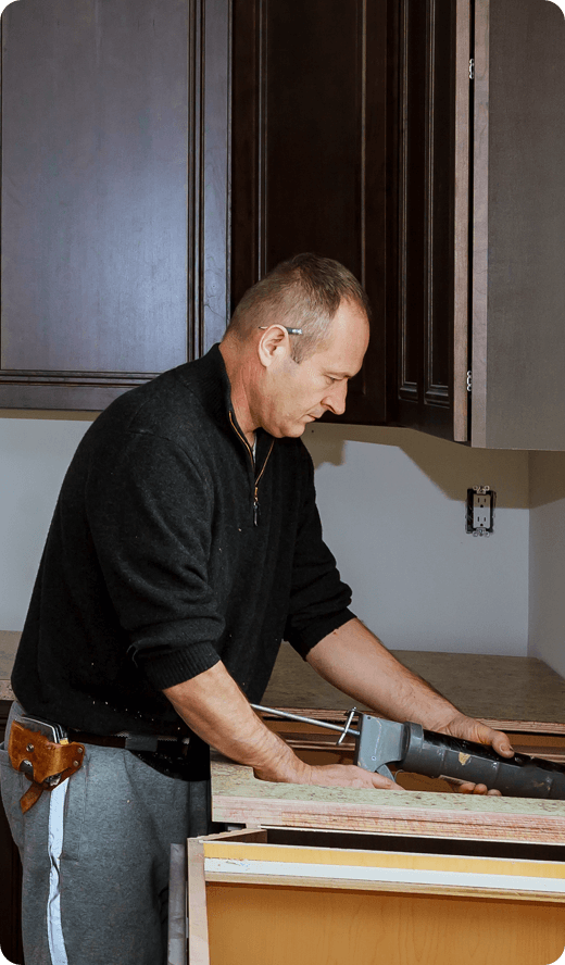 a man in black outfit working on a refurnishing