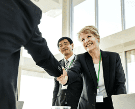 a woman shaking hands with franchise customer 