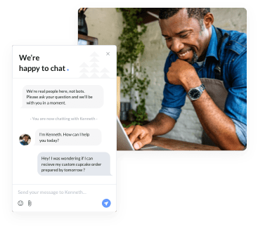 an elderly man smiling at the desktop screen